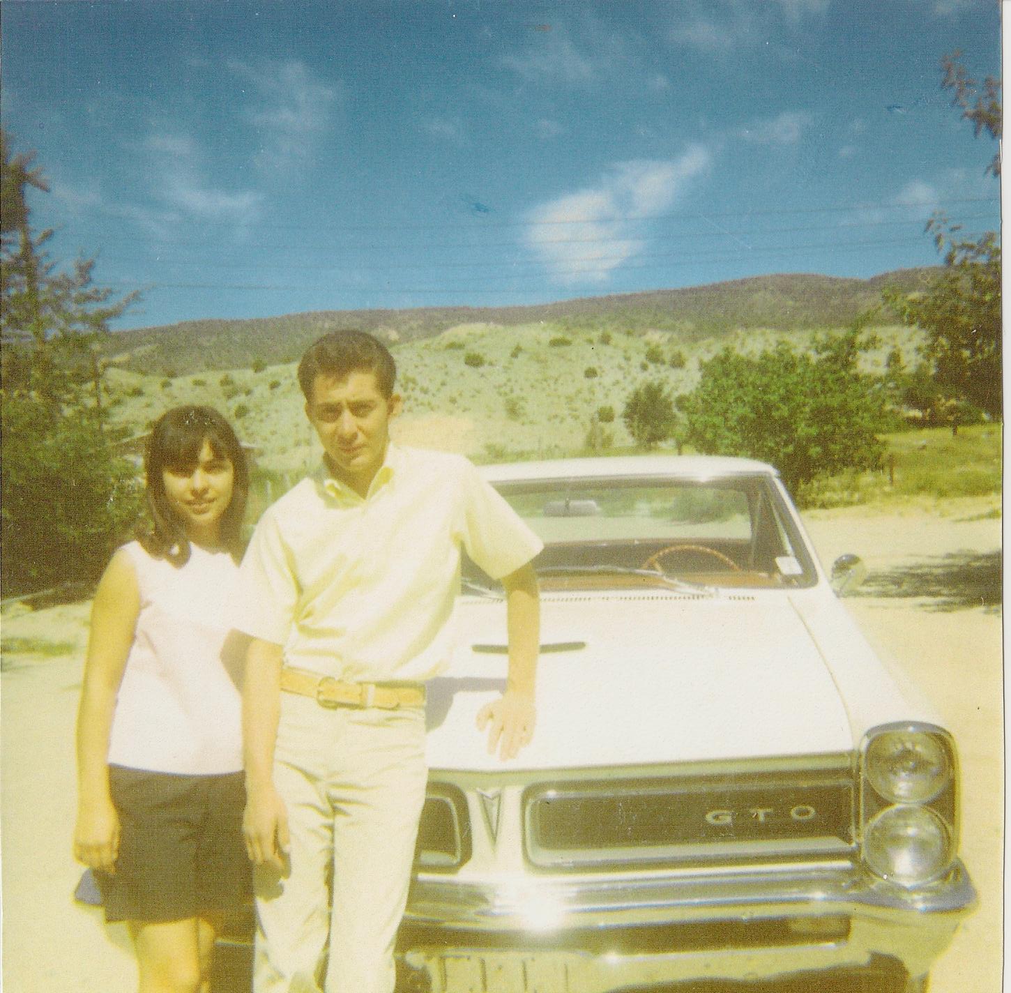 Larry and Lillian beside the white 1965 Pontiac GTO