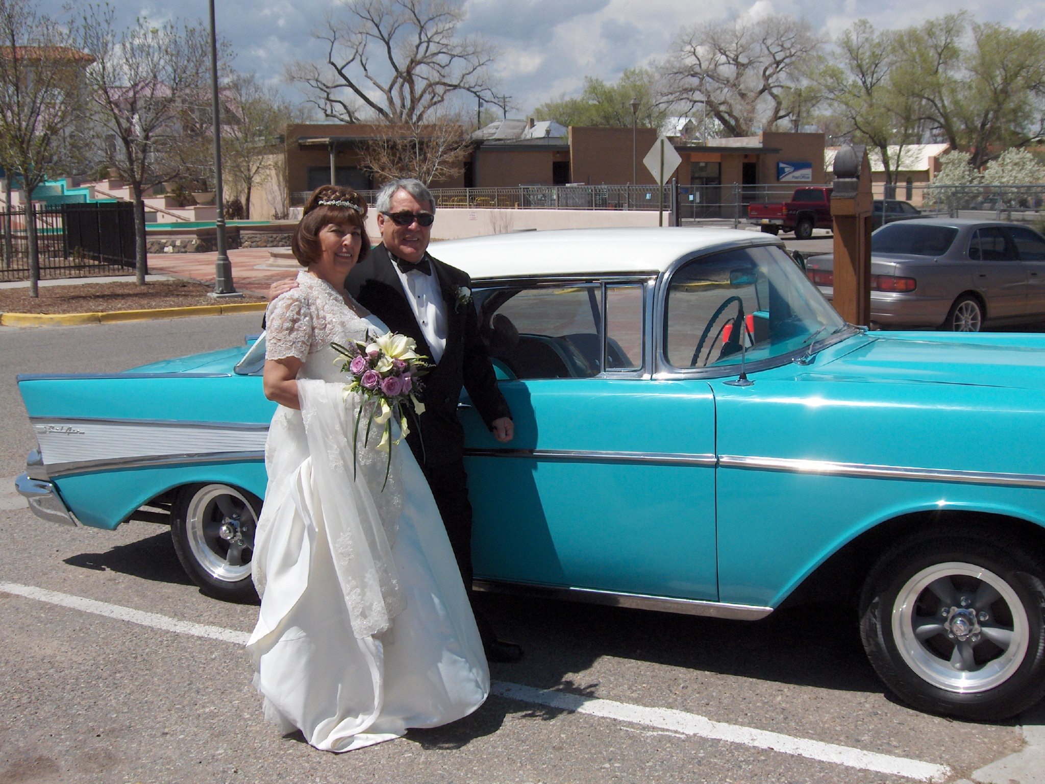 Larry and Lillian on their wedding day beside the turquoise 1957 Chevrolet Bel Air