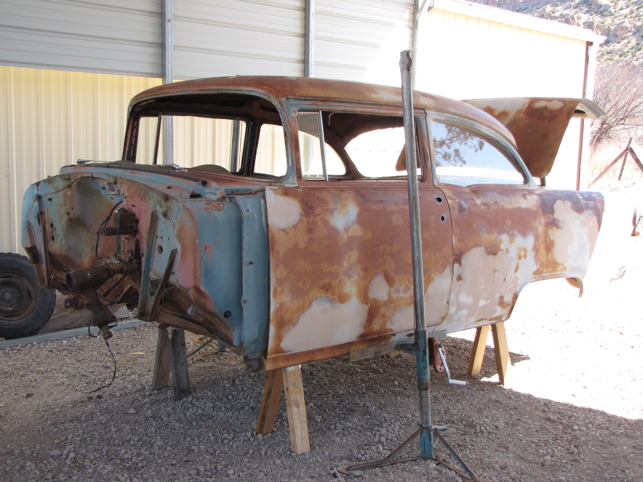 The stripped body of Midnight Storm raised on stands during restoration